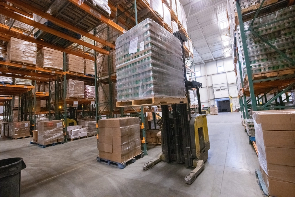 Warehouse aisles with tall shelving and stocked pallets